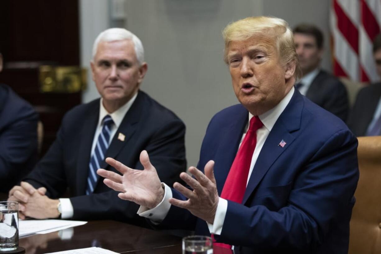 President Donald Trump with Vice President Mike Pence, speaks during a coronavirus briefing with Airline CEOs in the Roosevelt Room of the White House, Wednesday, March 4, 2020, in Washington.