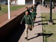 Children run during recess at the St. Agnes Elementary School in Phoenix, Ariz., on March 3, 2020. In 2016, the student body at St. Agnes was two-thirds Hispanic; the figure is now 95%, and virtually every student receives financial aid through state-approved tax credit programs that extend to private schools.