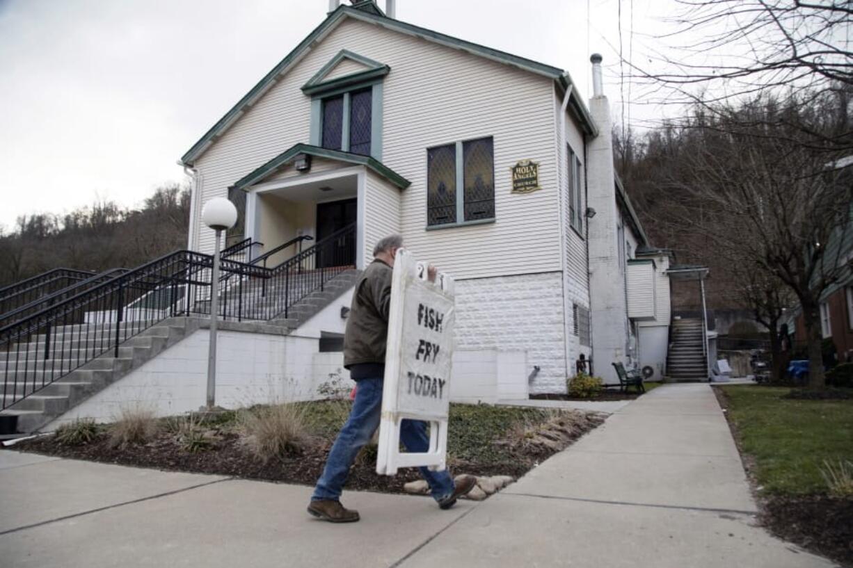 Mayor David Depretis of Baldwin Borough, Pa., takes in the sign announcing &quot;Fish Fry Today,&quot; on Feb. 28 after Holy Angels parish sold out of fish in Pittsburgh, Pa. On Thursday, Pittsburgh Bishop David Zubik suggested that people enjoy the fish as a take-out order rather than dining in due to virus concerns.