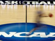 NCAA President Mark Emmert says NCAA Division I basketball tournament games will be played without fans in the arenas because of concerns about the spread of coronavirus.