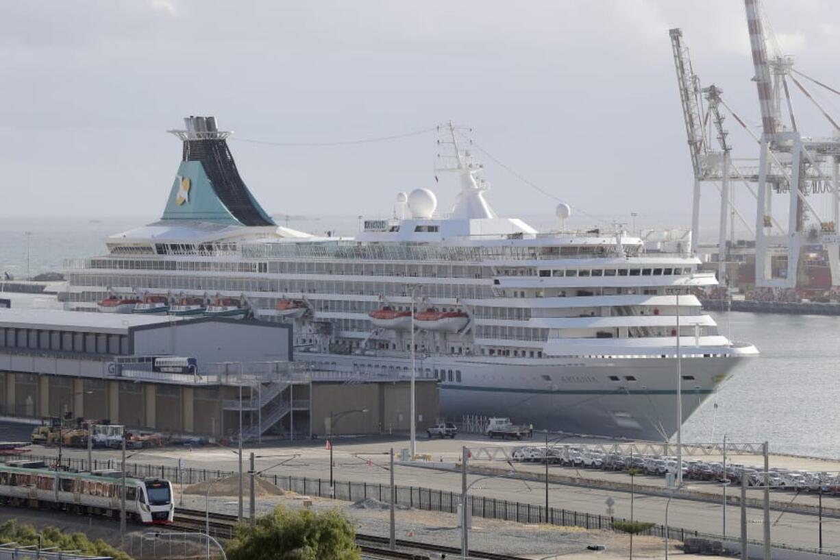 This Friday, March 27, 2020, photo shows the cruise ship Artania docked at Fremantle harbour in Fremantle, Australia. Authorities were still hoping to fly 800 cruise ship passengers from Australia to Germany on the weekend, but a sharp overnight rise in cases of the new coronavirus on board brought severe complications for the repatriation mission.