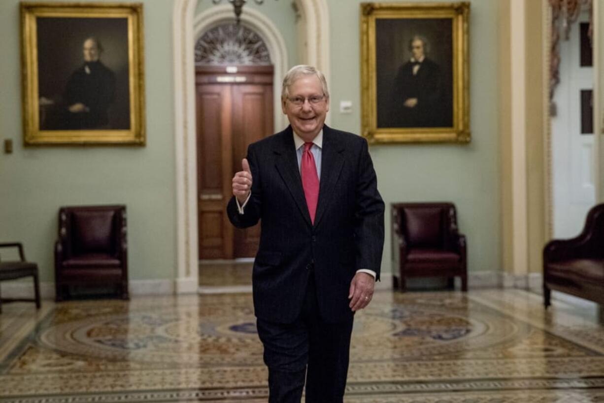 Senate Majority Leader Mitch McConnell of Ky. gives a thumbs up as he arrives on Capitol Hill, Wednesday, March 25, 2020, in Washington.