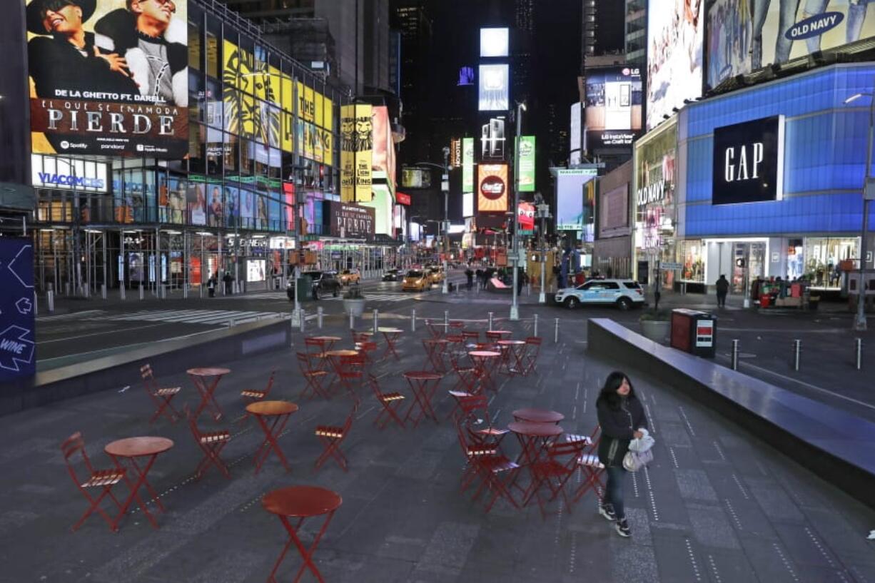 A woman walks through a lightly trafficked Times Square in New York on March 16.