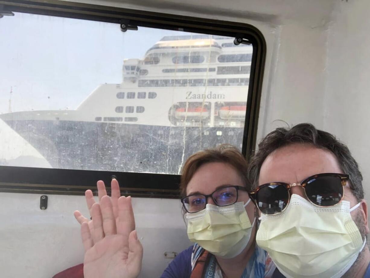 In this March 28, 2020 photo provided by Juan Huergo, Laura Gabaroni and her husband Juan Huergo take a selfie on board a tender after they were evacuated from the Zaandam, a Holland American cruise ship, near the Panama Canal. The Orlando- area couple was transferred to the Rotterdam, together with others who were deemed healthy. Four people have died on board the Zaandam and many others have are suffering from flu-like symptoms.