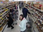 Shoppers stock up on canned items at WinCo Foods Friday, March 13, 2020 in Idaho Falls, Idaho. Idaho Gov. Brad Little declared a state of emergency Friday because of the new coronavirus.
