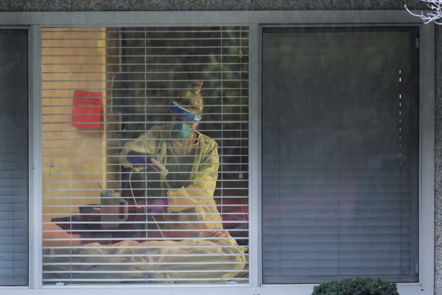 A nurse works March 13 in the room of a patient who tested positive for the COVID-19 coronavirus at the Life Care Center in Kirkland. Nursing home outbreaks of COVID-19 have raised concern in the U.S. since the incident at Life Care Center.