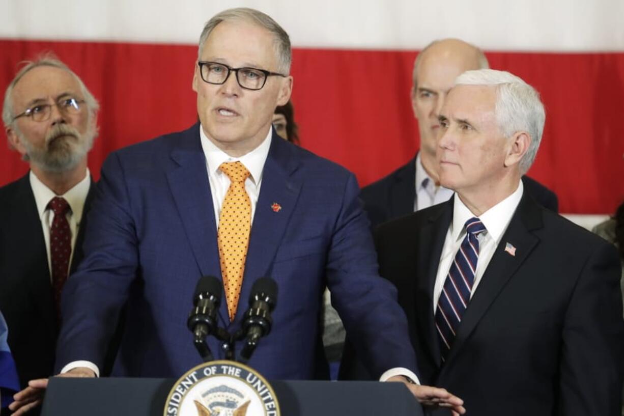 Vice President Mike Pence, right, looks on as Gov. Jay Inslee speaks during a news conference, Thursday, March 5, 2020, at Camp Murray in Washington state. Pence was in Washington to discuss the state&#039;s efforts to fight the spread of the COVID-19 coronavirus. Inslee&#039;s office announced Monday the governor won&#039;t hold any more public bill signings due to concerns about COVID-19. (AP Photo/Ted S.