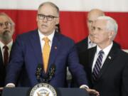 Vice President Mike Pence, right, looks on as Gov. Jay Inslee speaks during a news conference, Thursday, March 5, 2020, at Camp Murray in Washington state. Pence was in Washington to discuss the state&#039;s efforts to fight the spread of the COVID-19 coronavirus. Inslee&#039;s office announced Monday the governor won&#039;t hold any more public bill signings due to concerns about COVID-19. (AP Photo/Ted S.