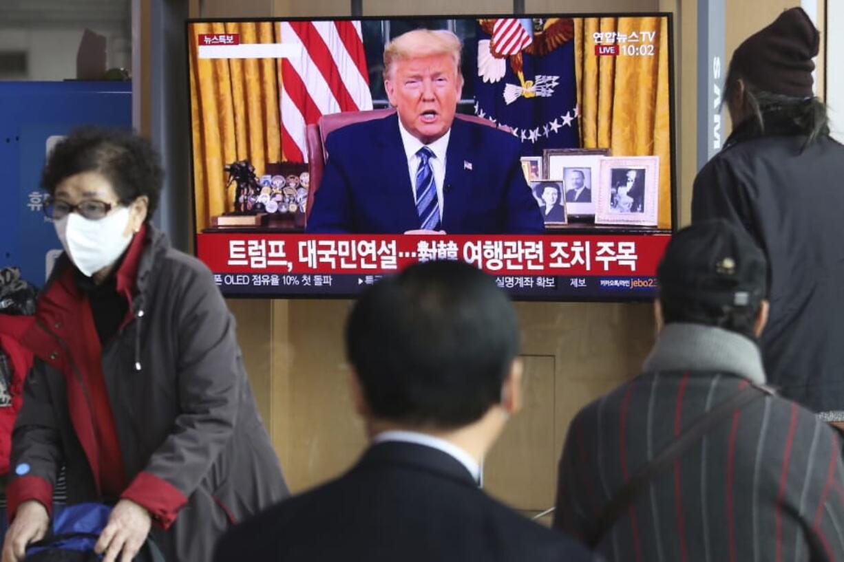 People watch a TV screen showing a live broadcast of U.S. President Donald Trump&#039;s speech at the Seoul Railway Station in Seoul, South Korea, Thursday, March 12, 2020. Trump announced he is cutting off travel from Europe to the U.S. and moving to ease the economic cost of a viral pandemic that is roiling global financial markets and disrupting the daily lives of Americans.