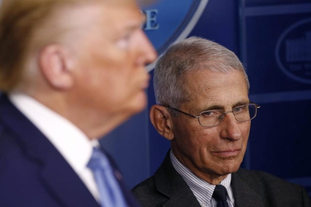 Director of the National Institute of Allergy and Infectious Diseases Dr. Anthony Fauci, right, and President Donald Trump listen as Vice President Mike Pence speaks during a coronavirus task force briefing at the White House, Saturday, March 21, 2020, in Washington.