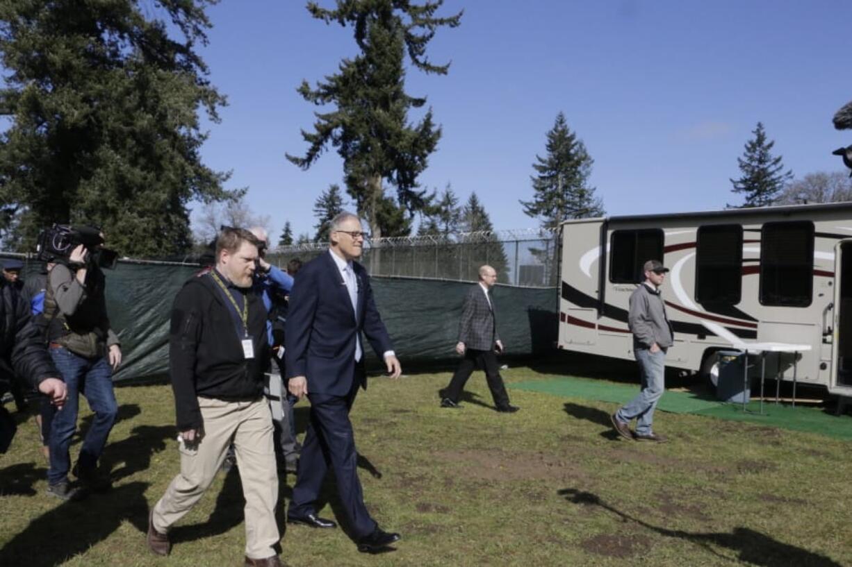 Gov. Jay Inslee, right, is joined by Nathan Weed, incident commander for the coronavirus response team at Department of Health, as they arrive at a potential coronavirus isolation and quarantine site Wednesday in Centralia.