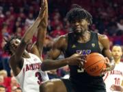 Washington forward Isaiah Stewart drives on Arizona guard Dylan Smith (3) during the first half of an NCAA college basketball game Saturday, March 7, 2020, in Tucson, Ariz. Smith broke his nose on the play.