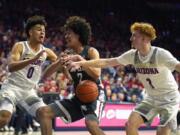 Arizona forward Josh Green (0) and Nico Mannion pressure Washington State forward CJ Elleby (2) in the first half of an NCAA college basketball game Thursday, March 5, 2020, in Tucson, Ariz.