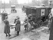 Members of the American Red Cross remove Spanish influenza victims from a house at Etzel and Page avenues in 1918. (St.