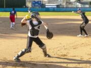 Mountain View catcher Kinsey Martin fields a bunt and fires to first base as Sydney Brown calls out in the background during a practice on March 11.