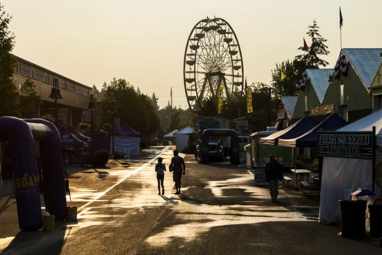 Two volunteers walk through the Clark County Fair before the doors open in 2018.