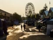 Two volunteers walk through the Clark County Fair before the doors open in 2018.