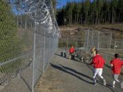 Inmates at Larch Corrections Center exercise in the yard in 2009.