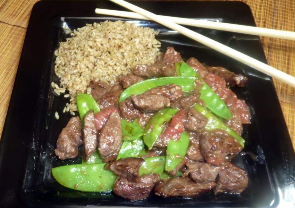 Stir-fried beef, along with crisp rice, takes on a unique twist with grapefruit on board.