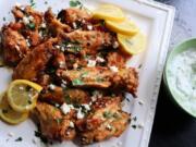 Greek-style wings are marinated in lemon, garlic and oregano and served with crumbled feta and tzatziki sauce.