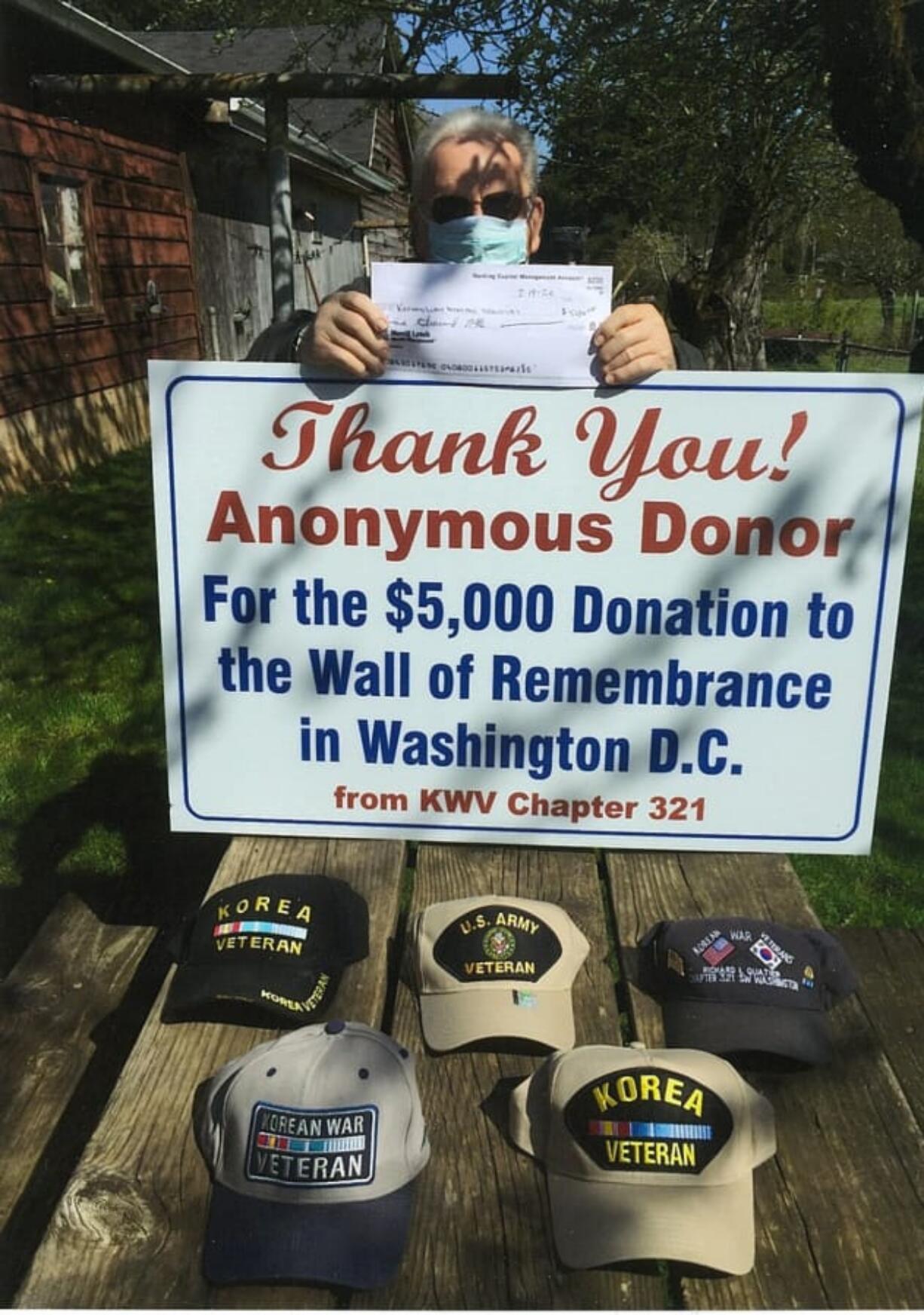 West Vancouver: Commander Ed Barnes shows the thank-you sign and copy of the check after an anonymous local donor gave $5,000 for a Wall of Remembrance for Korean War veterans.