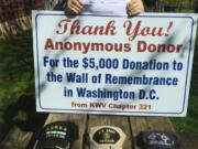 West Vancouver: Commander Ed Barnes shows the thank-you sign and copy of the check after an anonymous local donor gave $5,000 for a Wall of Remembrance for Korean War veterans.