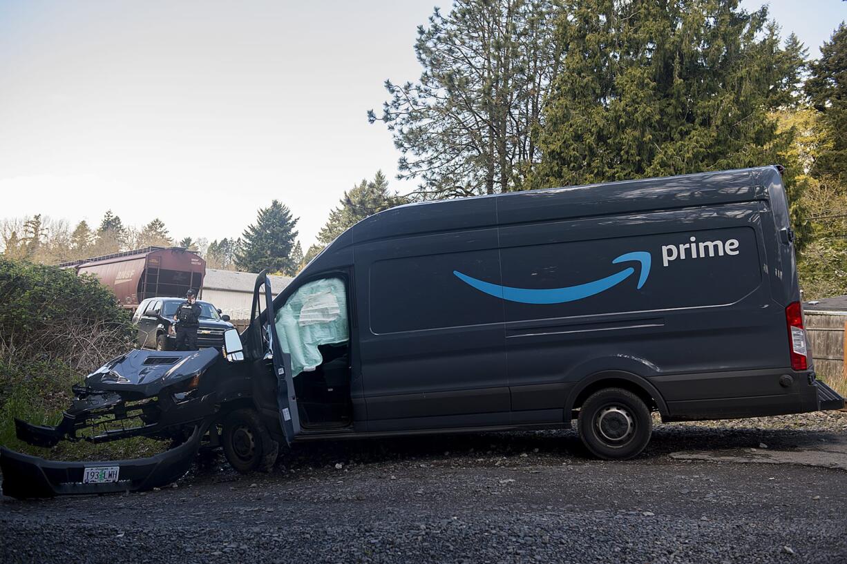 Police work at the scene after a train and a delivery truck collided near Southeast Evergreen Highway on Thursday morning, April 2, 2020.