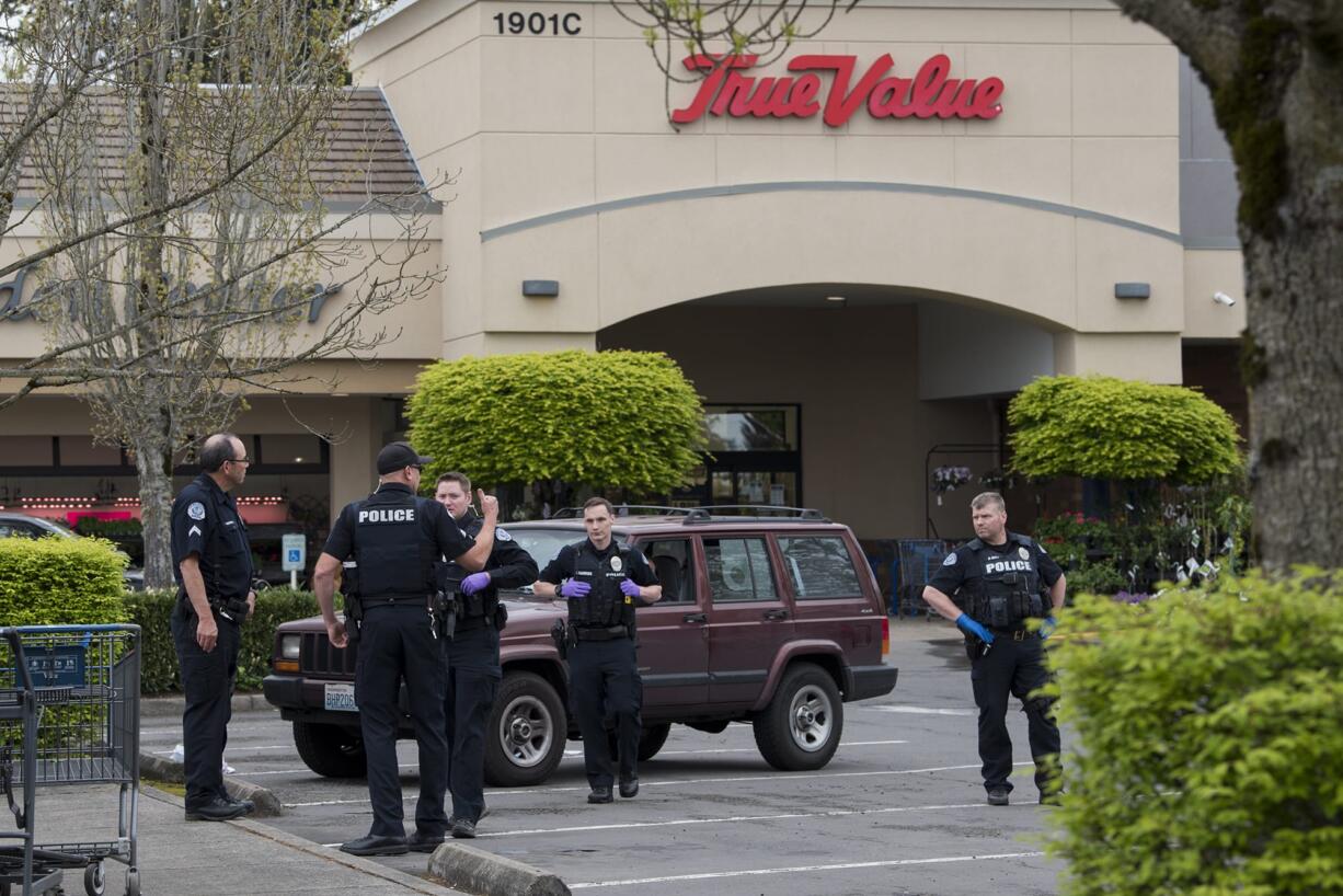 Police work at the scene of a stabbing in a parking lot in east Vancouver on Friday afternoon. The victim was seriously injured.