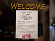 A sign on a business considered &quot;nonessential&quot; by the state notifies customers of its closure in downtown Vancouver late last month.