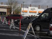 Car campers park their vehicles with space between them as they take refuge during the COVID-19 crisis at Vancouver Mall on Thursday. It was the first day officials were registering vehicles on a first-come, first-served basis to park at the mall. Participants have access to portable toilets and hand-washing stations.