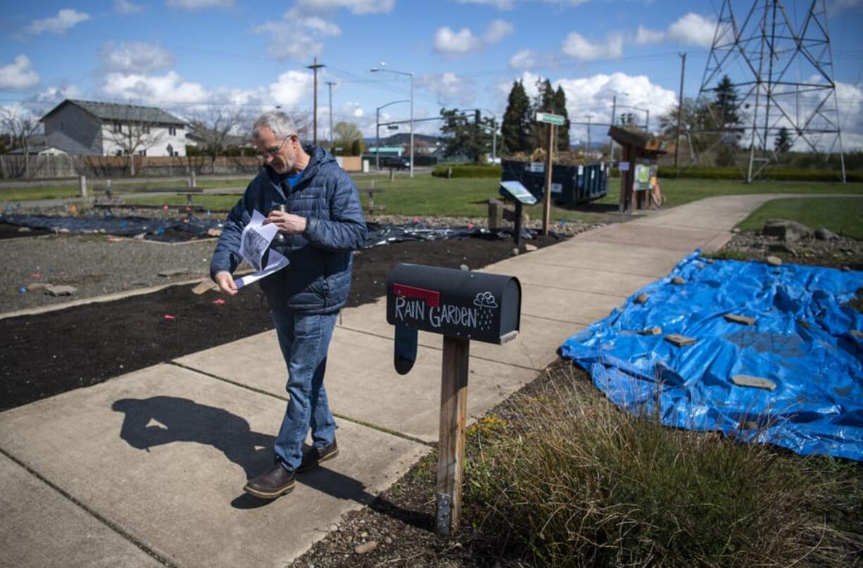 Pacific Middle School science teacher Tyler Carlson holds the map for his scavenger hunt at Pacific Community Park in Vancouver on Thursday.