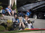 Alex and Jessica Queen and their kids take in a free neighborhood concert by Fox and Bones on Wednesday in Camas.