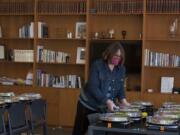 Above, Renita Keatley of Chabad Jewish Center of Clark County sets out Seder plate kits for local families to celebrate Passover at home on Wednesday.