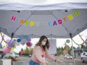Jessica Mofford cleans a metal basket used to deliver bags of plastic Easter eggs during Activate Church&#039;s drive-thru Easter egg hunt in Camas on Saturday morning, April 11, 2020.