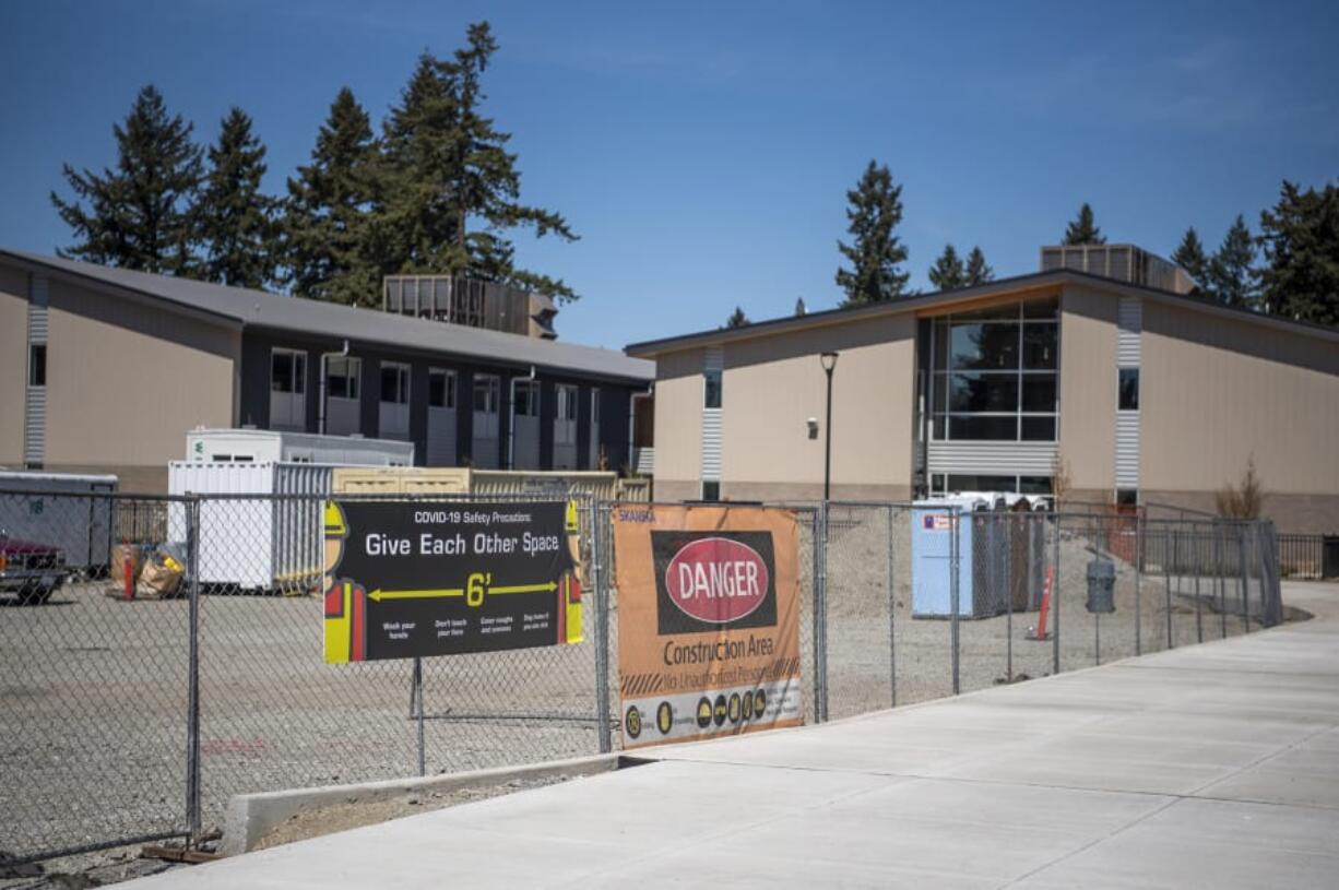 Construction continues at McLoughlin Middle School and George C. Marshall Elementary School in Vancouver on Thursday. School construction can continue despite moratoriums on most residential and commercial construction.