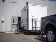 Volunteer Bob Bowling sets up the shower trailer at Living Hope Church in Vancouver on Friday. Due to the spread of coronavirus, the showers are now available on additional days for people in need.