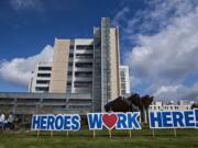 A sign outside PeaceHealth Southwest Medical Center honors hospital staff working hard to treat patients during the COVID-19 crisis Thursday morning, April 2, 2020.