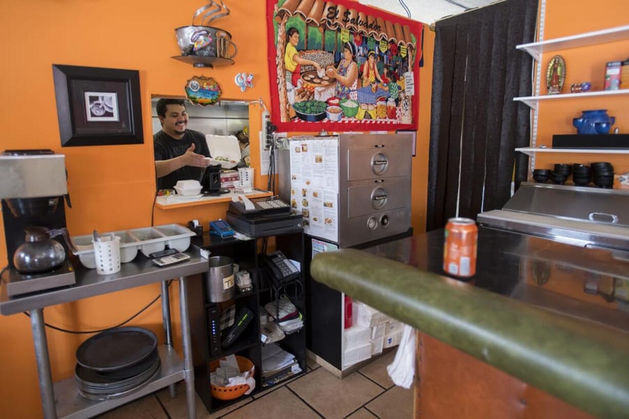 Robert Ayala, one of the owners of Mi Casa Pupuseria, prepares an order during Wednesday&#039;s lunch rush. Business has slowed down during the COVID-19 pandemic.