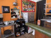 Robert Ayala, one of the owners of Mi Casa Pupuseria, prepares an order during Wednesday&#039;s lunch rush. Business has slowed down during the COVID-19 pandemic.