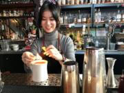 Virtual happy hour host Juliana Chau prepares a fiery cocktail concoction at The Grocery Cocktail &amp; Social.