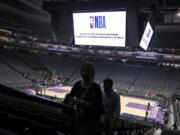 Fans leave the Golden 1 Center after the NBA basketball game between the New Orleans Pelicans and Sacramento Kings was postponed at the last minute in Sacramento, Calif., Wednesday, March 11, 2020. The league said the decision was made out of an &quot;abundance of caution,&quot; because official Courtney Kirkland, who was scheduled to work the game, had worked the Utah Jazz game earlier in the week. A player for the Jazz tested positive for the coronavirus.