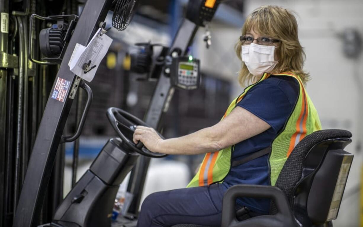 This photo provided by Cindy Parkhurst. shows Cindy Parkhurst working at the Ford Flat Rock Assembly Plant in Flat Rock, Mich.