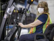 This photo provided by Cindy Parkhurst. shows Cindy Parkhurst working at the Ford Flat Rock Assembly Plant in Flat Rock, Mich.