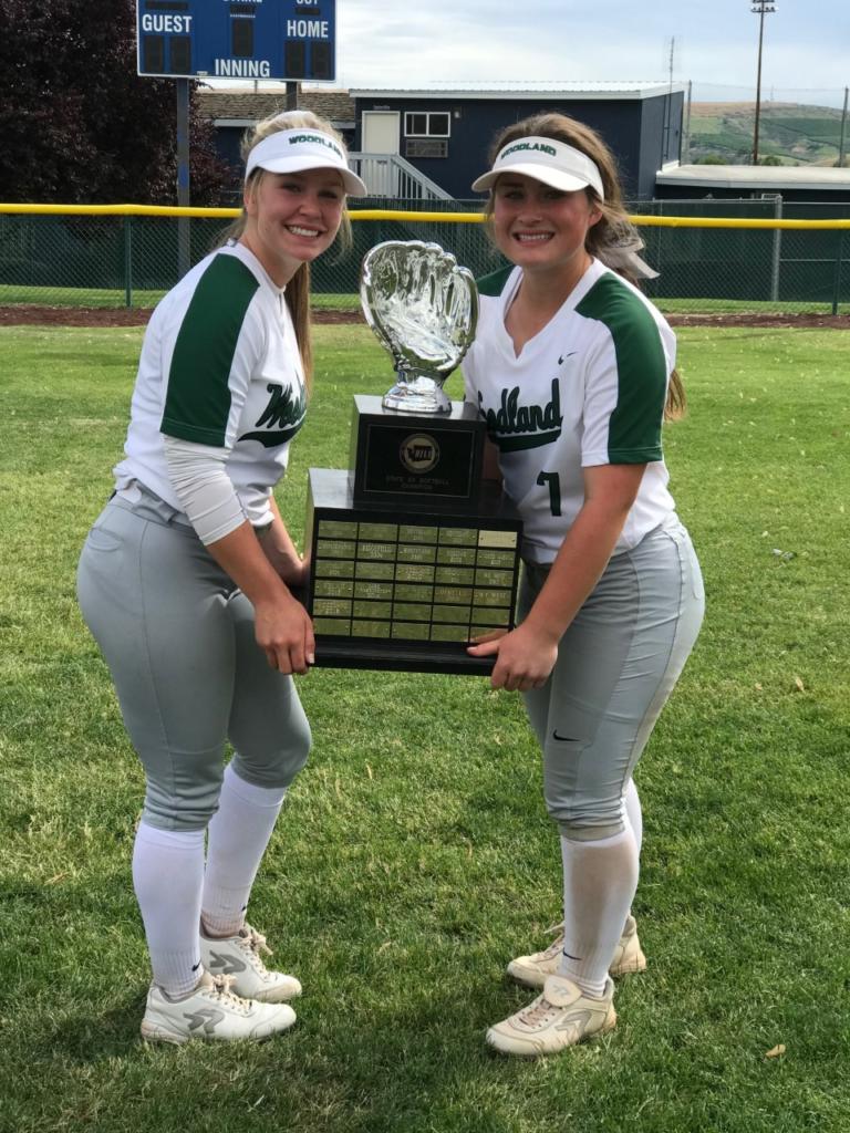 Kelly Sweyer (left) and Kaily Christensen hold the state championship trophy they won as part of the Woodland High School softball team (Photo courtesy of Woodland High School)