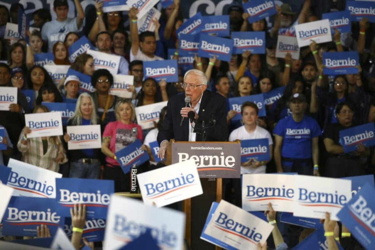 Supporters of Democratic presidential candidate Sen. Bernie Sanders, I-Vt., wave signs as Sanders speaks at a campaign rally March 5 in Phoenix. Sanders, who was popular among younger voters and potential voters, announced Wednesday that he was withdrawing from the race. (AP Photo/Ross D.