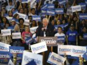 Supporters of Democratic presidential candidate Sen. Bernie Sanders, I-Vt., wave signs as Sanders speaks at a campaign rally March 5 in Phoenix. Sanders, who was popular among younger voters and potential voters, announced Wednesday that he was withdrawing from the race. (AP Photo/Ross D.