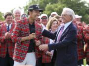 Kevin Na, front left, is congratulated by Charles Schwab after winning The Charles Schwab Challenge at Colonial on May 26, 2019, in Fort Worth, Texas. The PGA Tour laid out an ambitious plan to resume its season Thursday, April 16, 2020, with hopes of a restart at Colonial on June 11-14 and keeping fans away for at least the first month. (AP Photo/ Richard W.