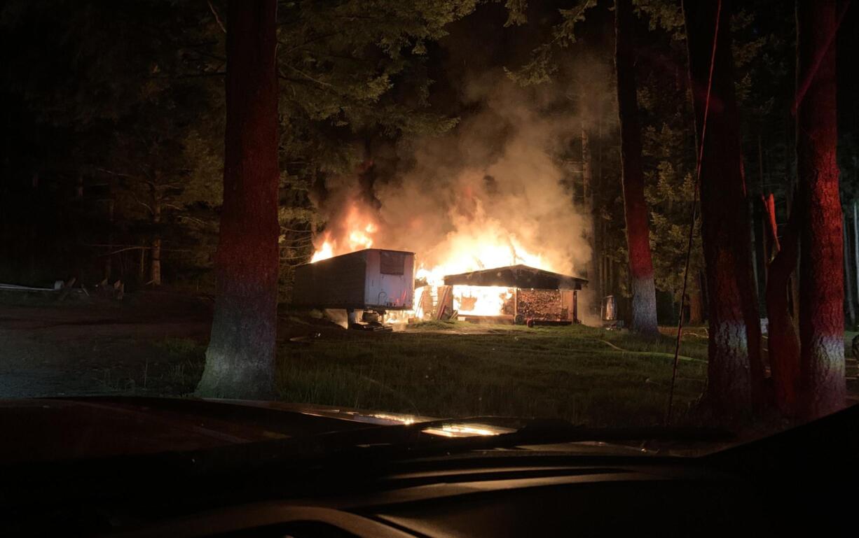 A fire destroyed a camper trailer and shop north of Washougal on Wednesday morning.