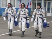 In this handout photo released by Roscosmos Space Agency Press Service U.S. astronaut Chris Cassidy, left, Russian cosmonauts Anatoly Ivanishin, centre, and Ivan Vagner, members of the main crew of the expedition to the International Space Station (ISS), walk prior the launch of Soyuz MS-16 space ship at the Russian leased Baikonur cosmodrome, Kazakhstan, Thursday, April 9, 2020.