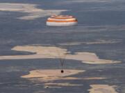 In this handout photo released by Gagarin Cosmonaut Training Centre (GCTC), Roscosmos space agency, the Soyuz MS-15 space capsule carrying International Space Station (ISS) crew members descends beneath a parachute just before landing in a remote area near Kazakh town of Dzhezkazgan, Kazakhstan, Friday, April 17, 2020. An International Space Station crew has landed safely after more than 200 days in space. The Soyuz capsule carrying NASA astronauts Andrew Morgan, Jessica Meir and Russian space agency Roscosmos&#039; Oleg Skripochka touched down on Friday on the steppes of Kazakhstan.